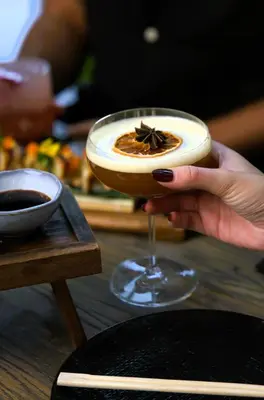 a woman holding a cocktail with a starstruck at Zabeel House The Greens by Jumeirah in Dubai