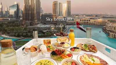 a table with plates of food on top of a balcony at Elite Royal Apartment - Full Burj Khalifa & Fountain View - Crystal in Dubai