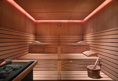 a sauna with a tub with a bucket in it at Grand Hyatt Residence in Dubai