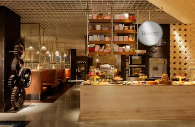 a restaurant with a counter with food on it at Grand Hyatt Residence in Dubai