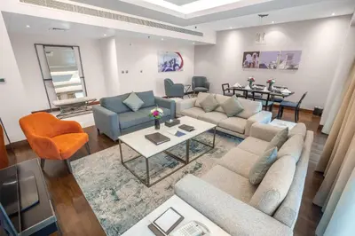 a living room with couches and chairs and a table at City Premiere Hotel Apartments - Dubai in Dubai