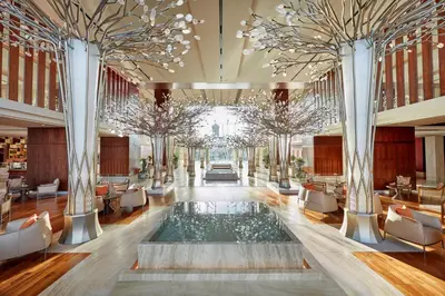a lobby with a pool in the middle of a building at Mandarin Oriental Jumeira, Dubai in Dubai