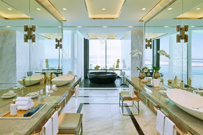 a bathroom with two sinks and a bath tub at Mandarin Oriental Jumeira, Dubai in Dubai