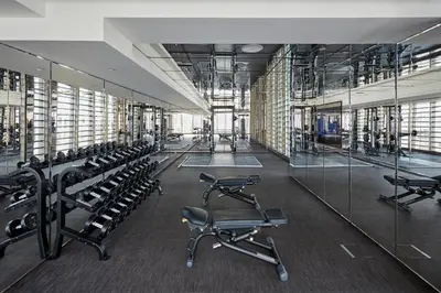 a gym with rows of exercise bikes and mirrors at Mandarin Oriental Jumeira, Dubai in Dubai