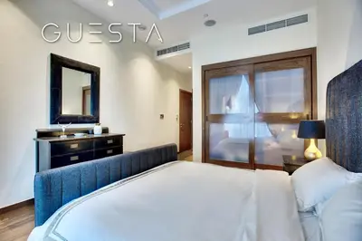 a bedroom with a bed and a mirror at Oceana Residences, Free beach & pool access in Dubai