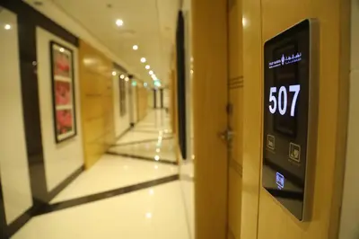 an empty hallway with a slow sign on a door at Tulip Al Barsha Hotel Apartment in Dubai