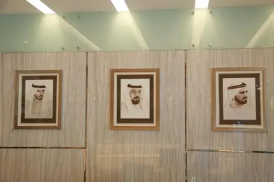 three framed pictures of men on a wall at Tulip Al Barsha Hotel Apartment in Dubai