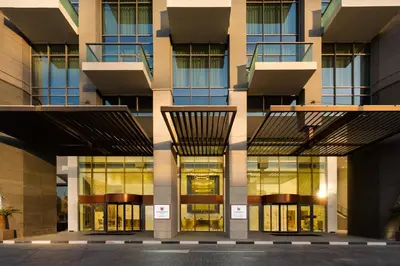 a facade of a building with glass windows at Millennium Atria Business Bay in Dubai