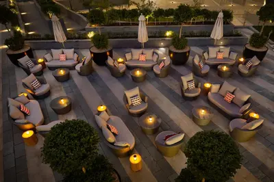 an overhead view of a patio with couches and lights at Millennium Atria Business Bay in Dubai
