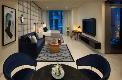 a living room with a couch and a tv at Millennium Atria Business Bay in Dubai