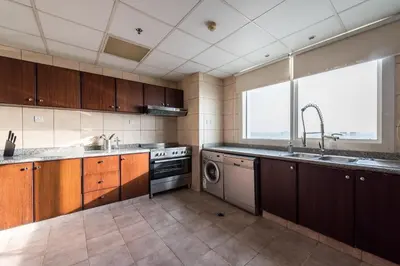 a large kitchen with a sink and a dishwasher at EDEN'S Homes & Villas - KG Tower in Dubai