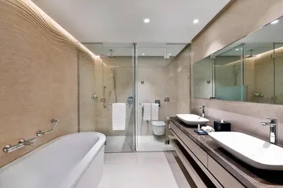 a bathroom with two sinks and a tub and a shower at Courtyard by Marriott Dubai, Al Barsha in Dubai
