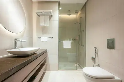 a bathroom with a sink and a glass shower at Courtyard by Marriott Dubai, Al Barsha in Dubai