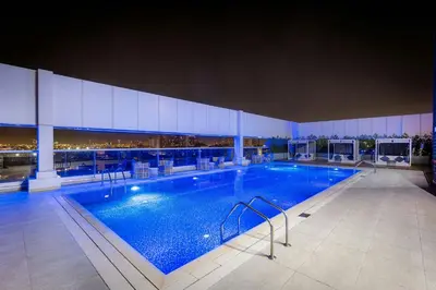 a large swimming pool in a building at Courtyard by Marriott Dubai, Al Barsha in Dubai