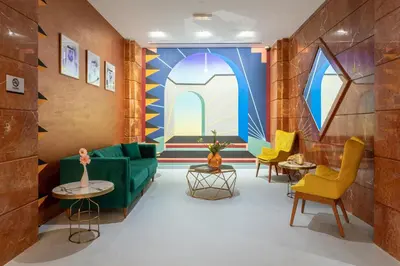 a living room with a green couch and chairs at Leva Hotel and Suites, Opposite Downtown in Dubai
