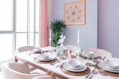 a dining room table with chairs and a white dining room table at Ultimate Stay 2BR: Burj Khalifa and fountain view in Dubai