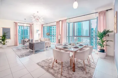 a living room with a table and chairs and a couch at Ultimate Stay 2BR: Burj Khalifa and fountain view in Dubai
