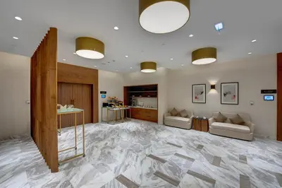 a large room with a marble floor and two couches at The S Hotel Al Barsha in Dubai