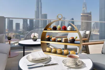a shelf of pastries on a table on a balcony at Address Dubai Mall in Dubai