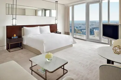a hotel room with a large bed and a living room at Address Sky View, Downtown Dubai in Dubai