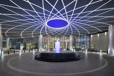 a large building with a fountain in front of it at Address Sky View, Downtown Dubai in Dubai
