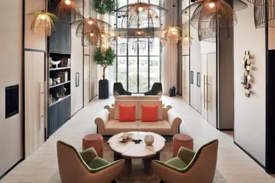 a living room with a couch and chairs and a table at Vida Emirates Hills in Dubai