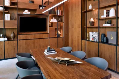 a conference room with a wooden table and chairs at Vida Emirates Hills in Dubai
