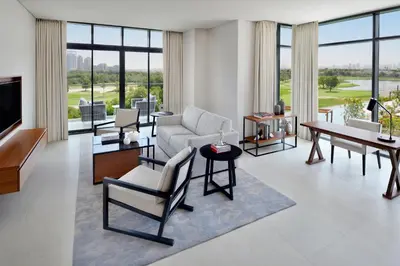 a living room with a couch and a table at Vida Emirates Hills in Dubai