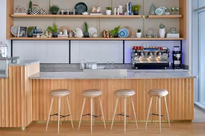a kitchen with a counter with bar stools at Vida Creek Harbour in Dubai