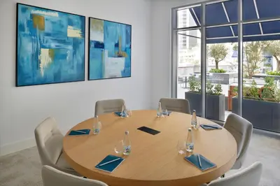 a conference room with a wooden table and chairs at Vida Creek Harbour in Dubai