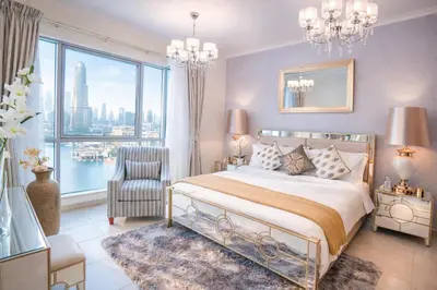 a bedroom with a bed and a large window at Elite Royal Apartment | Burj Residences Tower 5 | Gold in Dubai