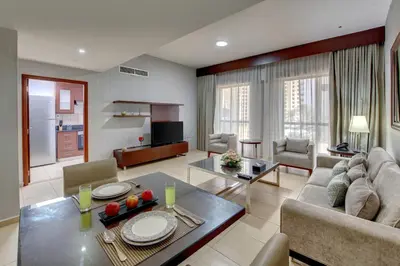 a living room with a couch and a table at SUHA JBR Hotel Apartments in Dubai