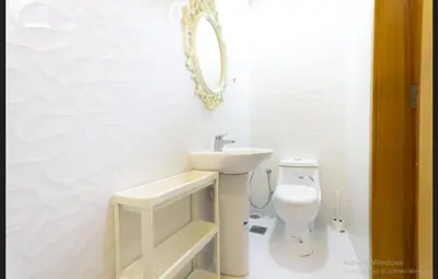 a white bathroom with a sink and a toilet at Budget Rooms With Private Bathroom for 'girls' only in Dubai, Marina in Dubai