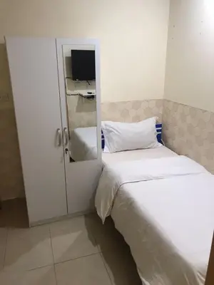 a small bedroom with two beds and a tv at Budget Rooms With Private Bathroom for 'girls' only in Dubai, Marina in Dubai
