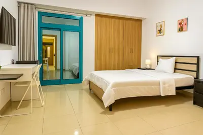 a bedroom with a bed and a desk and a sink at Classy Studios for Ladies in Dubai, Marina فتيات فقط in Dubai