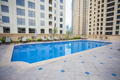 a swimming pool in the middle of a building at Big Studio in Rimal at The Beach JBR in Dubai