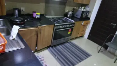 a kitchen with a stove top oven in a kitchen at Small Budget Rooms for 'girls' only in Dubai, Marina in Dubai
