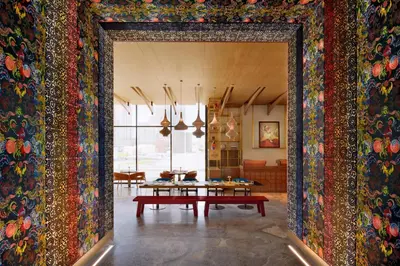 a room with a table and a wall covered in colorful carpet at Hotel Indigo Dubai Downtown by IHG in Dubai