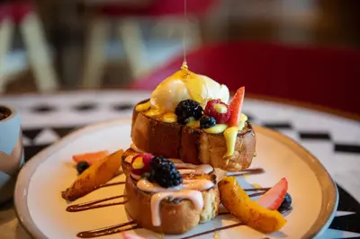 a plate with a dessert with fruit and ice cream on it at Hotel Indigo Dubai Downtown by IHG in Dubai