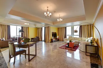 a living room with a couch and a table at Abidos Hotel Apartment Dubai Land in Dubai