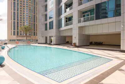 a large swimming pool in front of a building at Luton Vacation Homes - The Marina Torch - Sea view - 64AB07 in Dubai