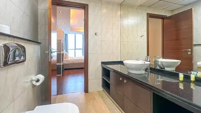 a bathroom with two sinks and a toilet at Luton Vacation Homes - The Marina Torch - Sea view - 64AB07 in Dubai