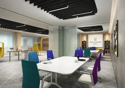 a conference room with a white table and purple chairs at Millennium Al Barsha in Dubai