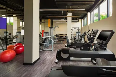a gym with treadmills and exercise equipment in a building at Millennium Al Barsha in Dubai