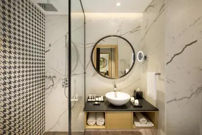 a bathroom with a sink and a shower at Millennium Al Barsha in Dubai