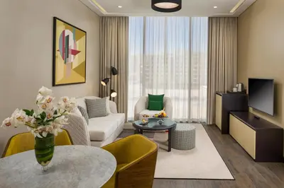 a living room with a couch and a table at Millennium Al Barsha in Dubai