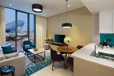 a kitchen and living room with a couch and a table at Millennium Al Barsha in Dubai