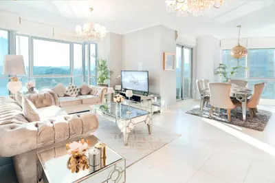 a living room with a couch and a table at Elite Royal Apartment - Full Bujr Khalifa & Fountain View - Senator - 2 bedrooms & 1 open bedroom without partition in Dubai