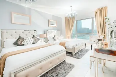 a bedroom with two beds and a living room at Elite Royal Apartment - Full Bujr Khalifa & Fountain View - Senator - 2 bedrooms & 1 open bedroom without partition in Dubai