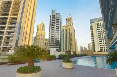 a view of a city skyline with a pool and buildings at Prime Retreats - Downtown Dubai in Dubai